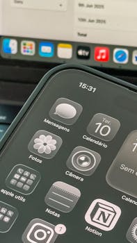 Close-up shot of a smartphone displaying apps and calendar on the screen.