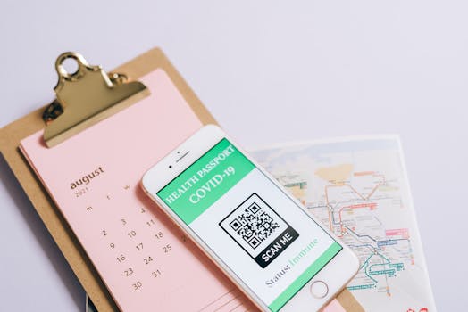 Smartphone with health passport and calendar for organized travel planning.