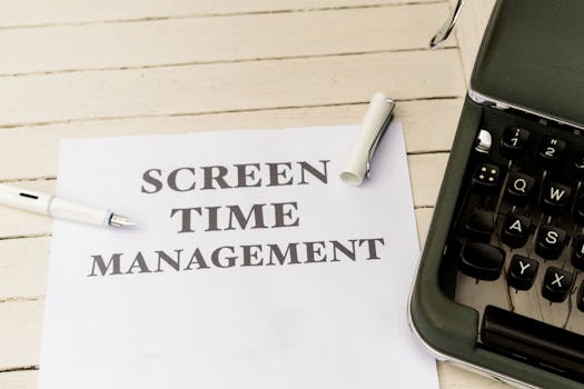 Typewriter with paper titled 'Screen Time Management' on a wooden table.